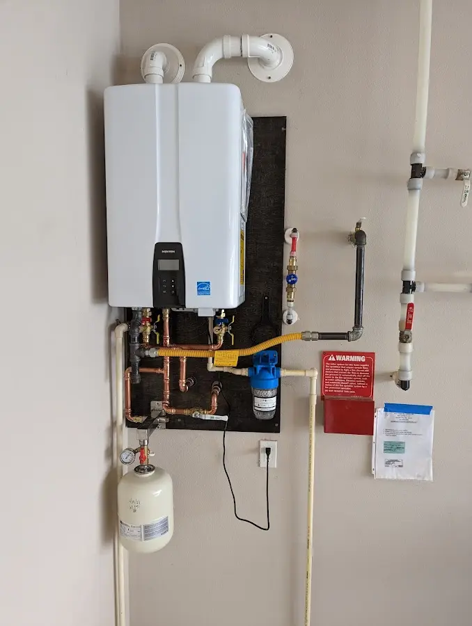 Professional plumber installing copper piping in a North Cornwall home